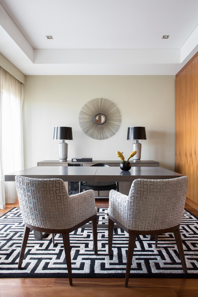 Inspiration for a mid-sized contemporary freestanding desk medium tone wood floor study room remodel in Sydney with beige walls