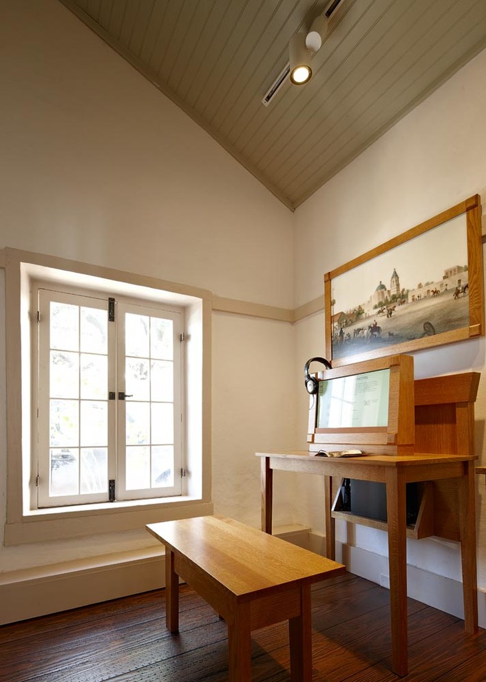 Ejemplo de despacho clásico de tamaño medio sin chimenea con paredes blancas, suelo de madera en tonos medios y escritorio independiente
