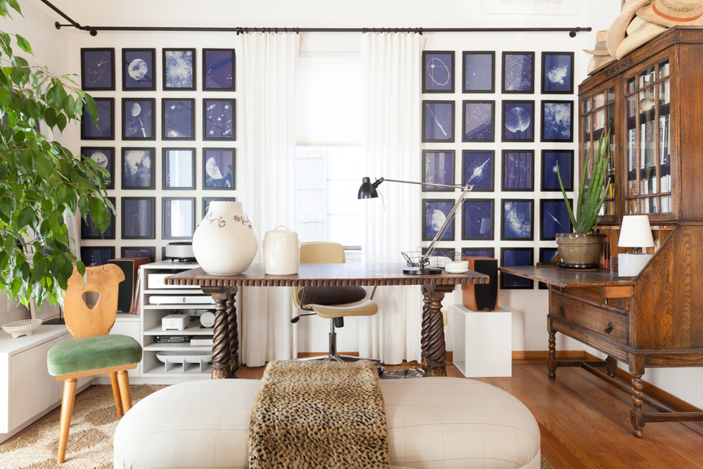 Medium sized eclectic study in San Francisco with white walls, medium hardwood flooring and a freestanding desk.