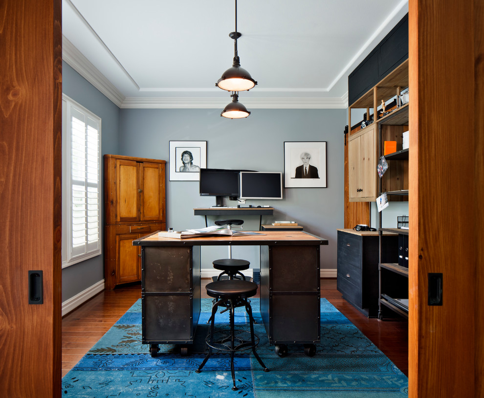Cette image montre un bureau urbain de taille moyenne avec un mur gris, un sol en bois brun, aucune cheminée et un bureau indépendant.