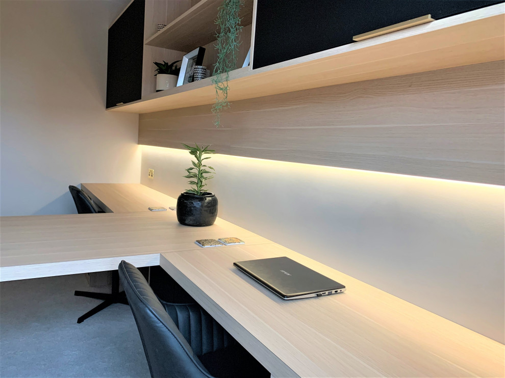 Example of a small trendy built-in desk carpeted and beige floor study room design in Other with beige walls