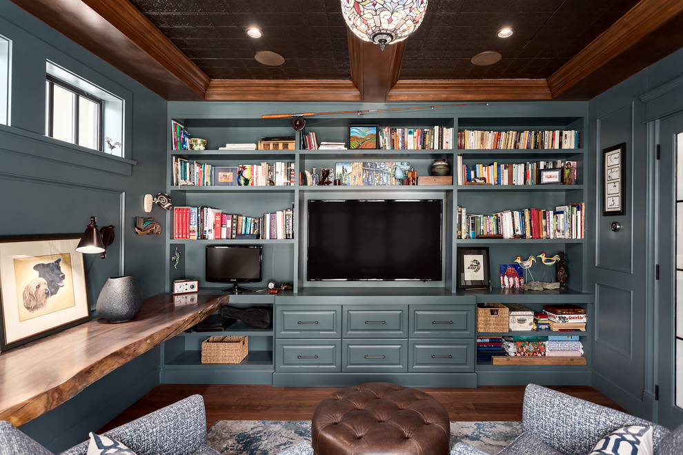 Inspiration for a mid-sized timeless built-in desk medium tone wood floor and brown floor study room remodel in Vancouver with blue walls and no fireplace