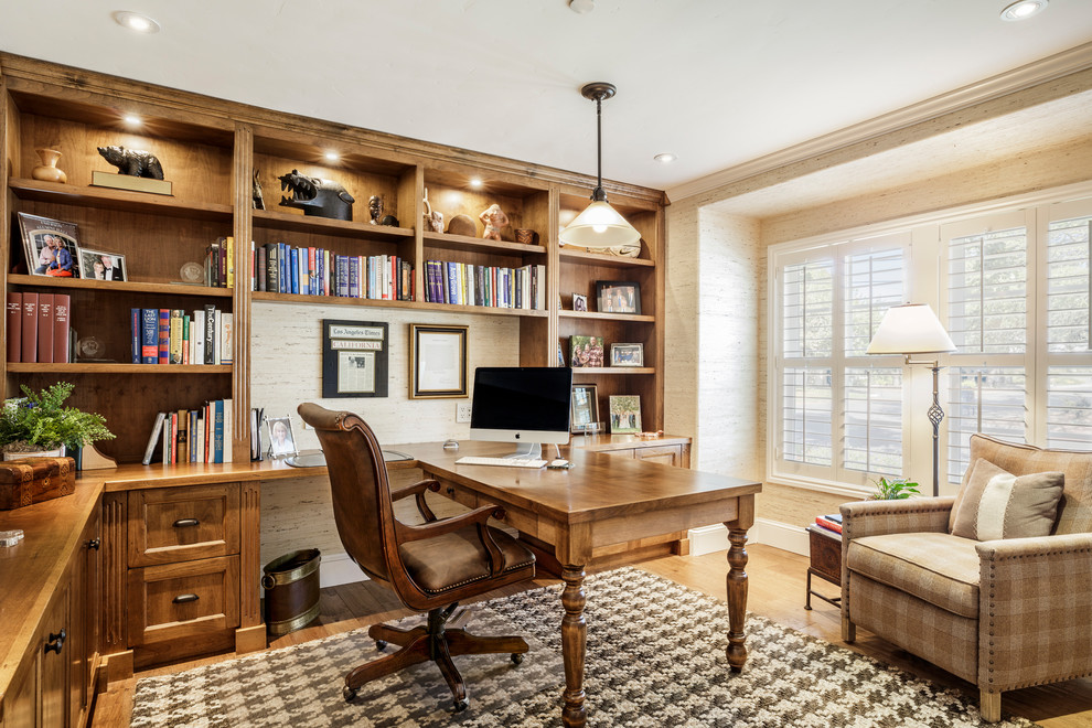 This is an example of a large classic home office in Orange County with beige walls, medium hardwood flooring, a built-in desk, a reading nook and no fireplace.