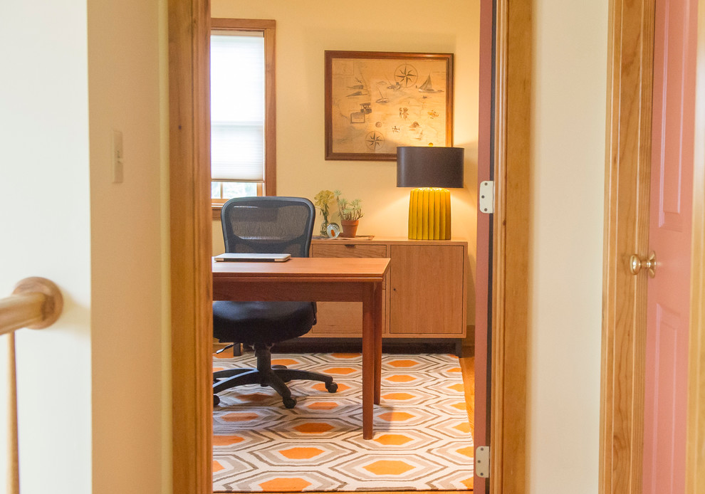 Idées déco pour un bureau moderne de taille moyenne avec un sol en bois brun, aucune cheminée, un bureau indépendant et un mur beige.