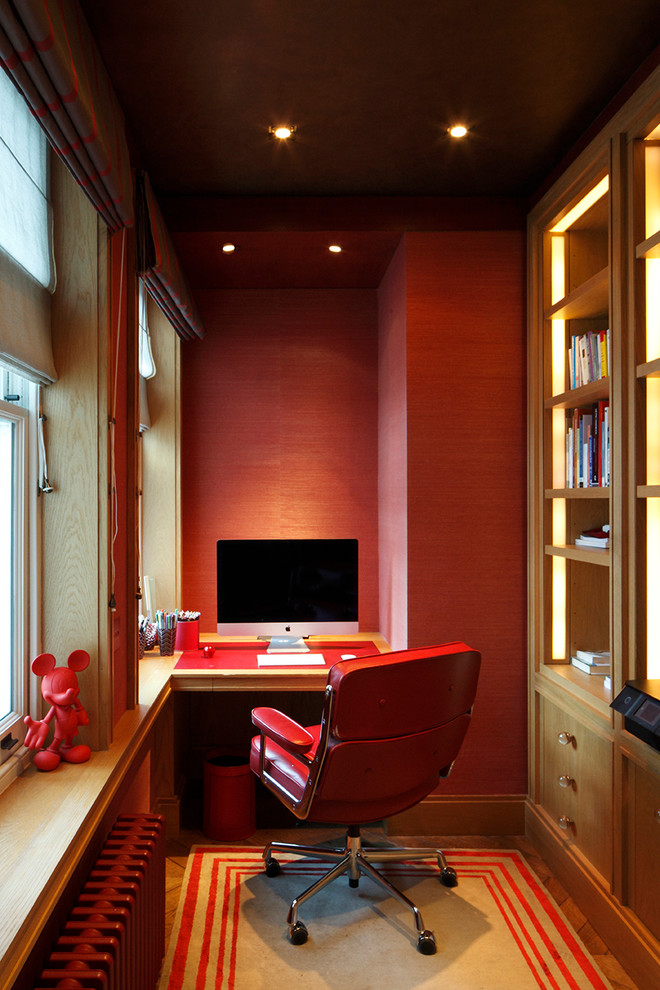 Inspiration for a medium sized traditional study in London with red walls, dark hardwood flooring, a built-in desk and brown floors.