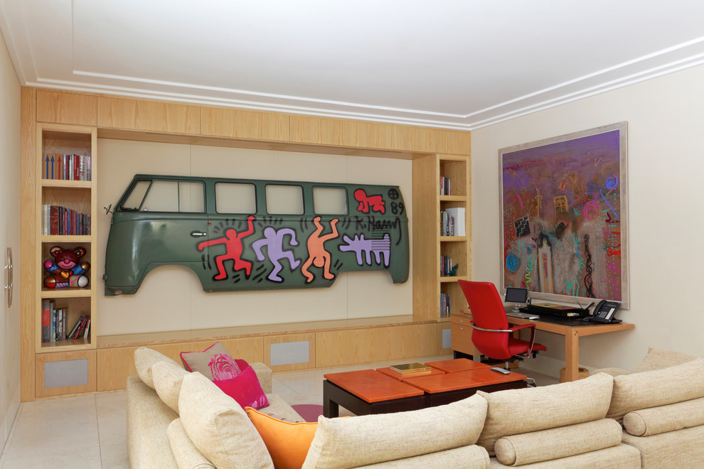 Example of a trendy built-in desk beige floor home office library design in London with beige walls