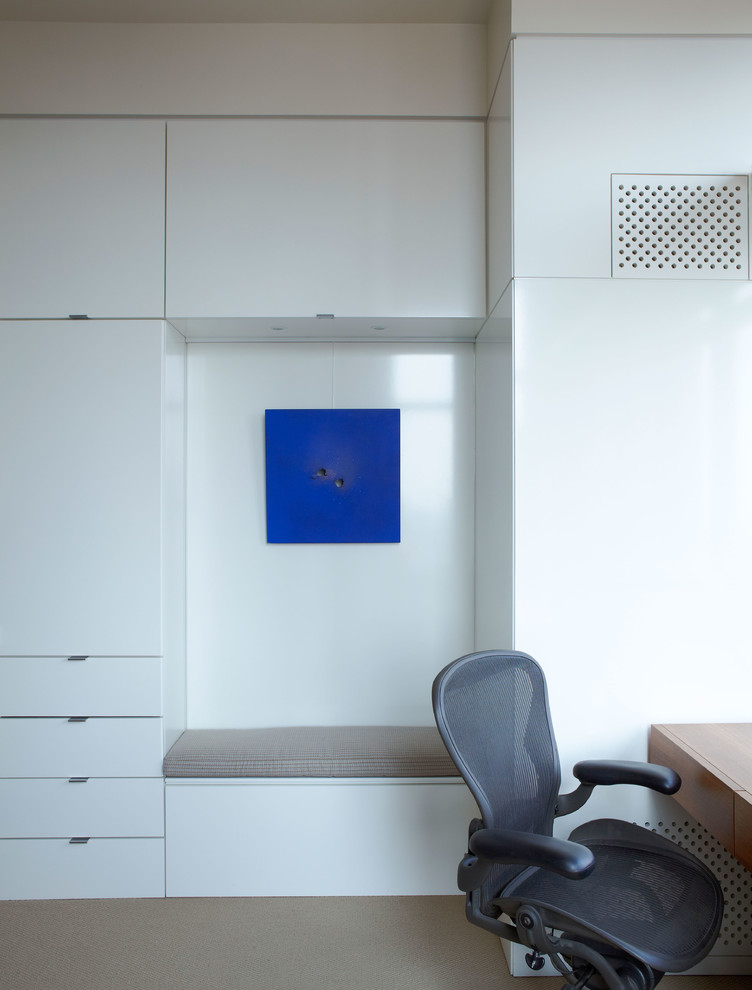 Esempio di uno studio design con scrivania incassata, pareti bianche e moquette