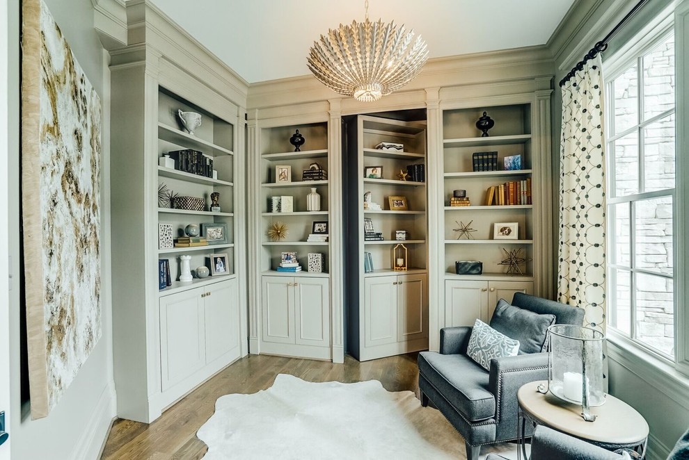 Inspiration for a mid-sized transitional medium tone wood floor study room remodel in Richmond with beige walls