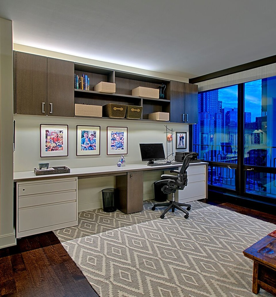 Home office - mid-sized contemporary built-in desk dark wood floor home office idea in Chicago with gray walls and no fireplace