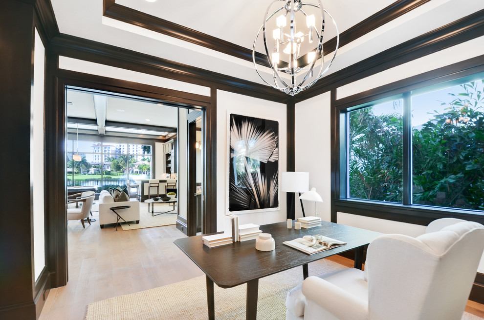 Example of a large transitional freestanding desk medium tone wood floor and brown floor study room design in Miami with white walls and no fireplace