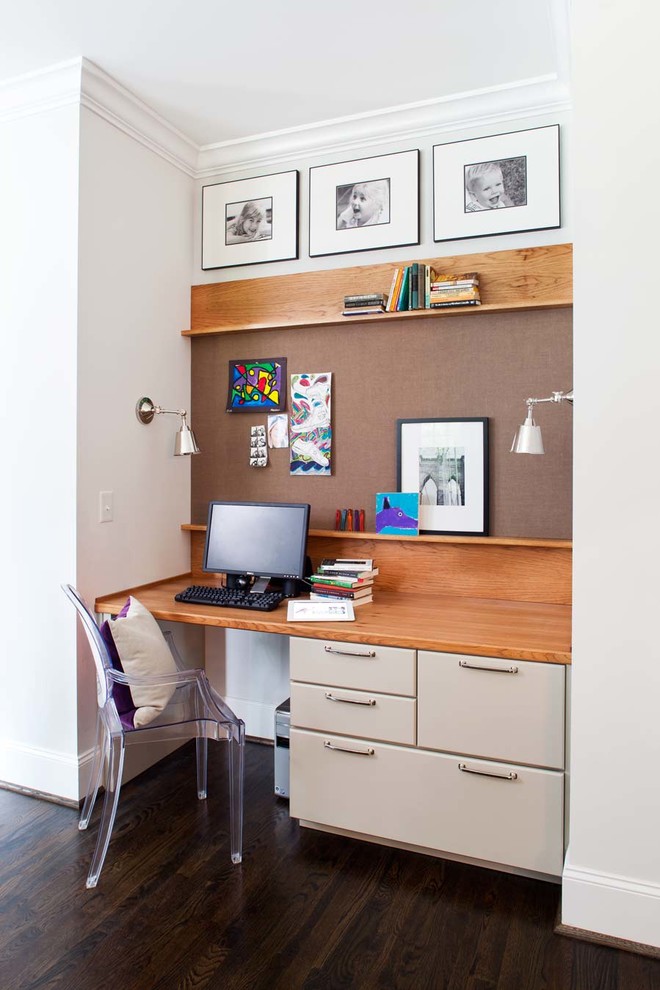 This is an example of a small contemporary study in Atlanta with a built-in desk, grey walls and dark hardwood flooring.