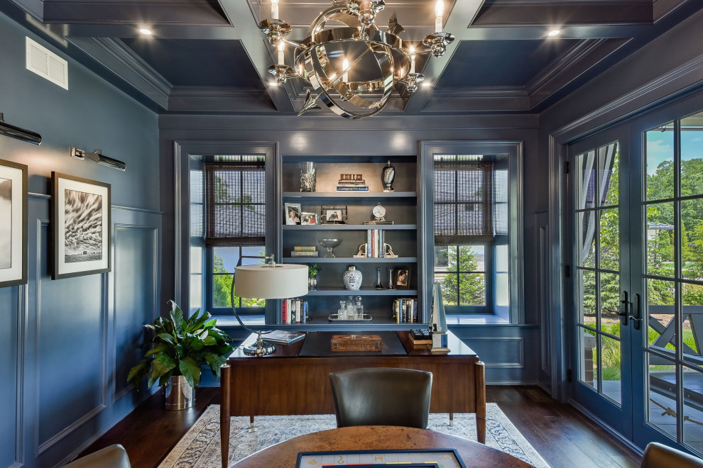Design ideas for a large traditional study in Chicago with blue walls, dark hardwood flooring, no fireplace, a freestanding desk, a coffered ceiling and wainscoting.