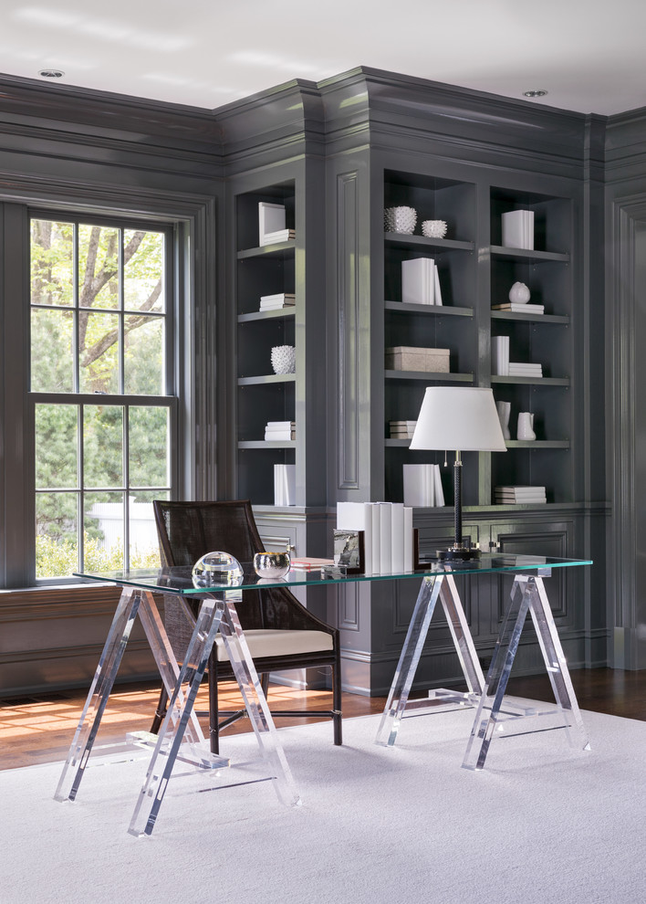 Inspiration for a large transitional freestanding desk dark wood floor and brown floor home office library remodel in Other with gray walls, a standard fireplace and a stone fireplace