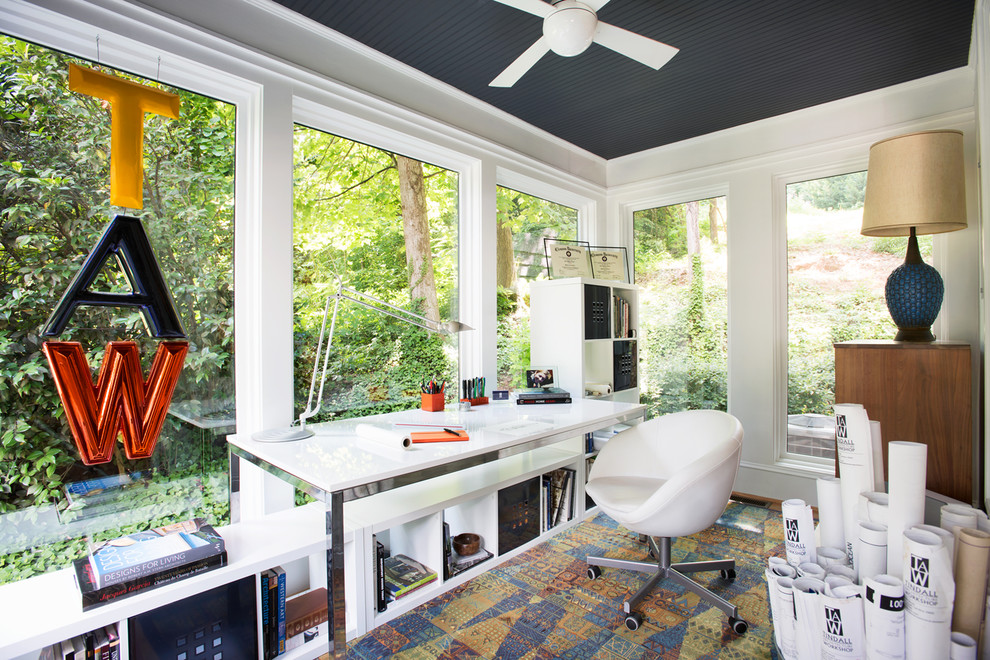 Small minimalist freestanding desk medium tone wood floor home studio photo in Atlanta with white walls