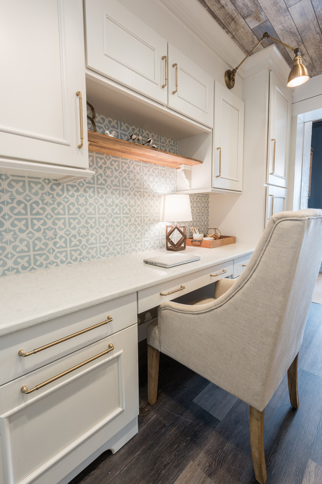 Modelo de despacho de estilo de casa de campo pequeño con paredes blancas, suelo vinílico, escritorio empotrado y suelo marrón