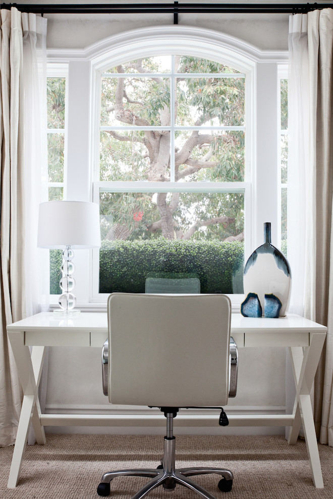 Large beach style freestanding desk carpeted home office photo in Orange County with beige walls and no fireplace