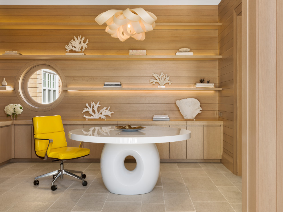Inspiration for a beach style home office in San Francisco with brown walls, porcelain flooring, no fireplace, a freestanding desk, beige floors and wood walls.