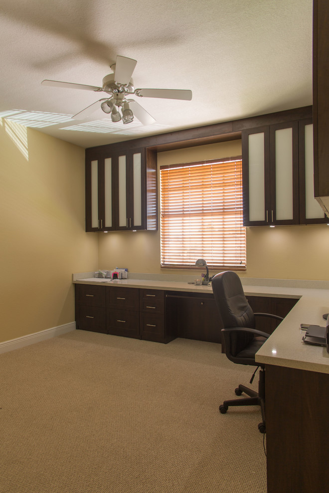 Mid-sized transitional built-in desk carpeted study room photo in Miami with beige walls and no fireplace