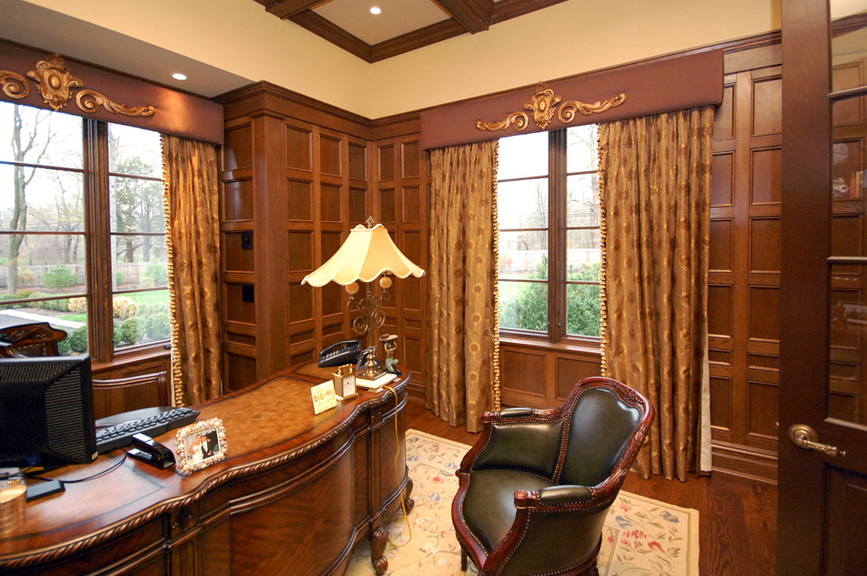 Example of a mid-sized classic freestanding desk dark wood floor study room design in New York with beige walls and no fireplace