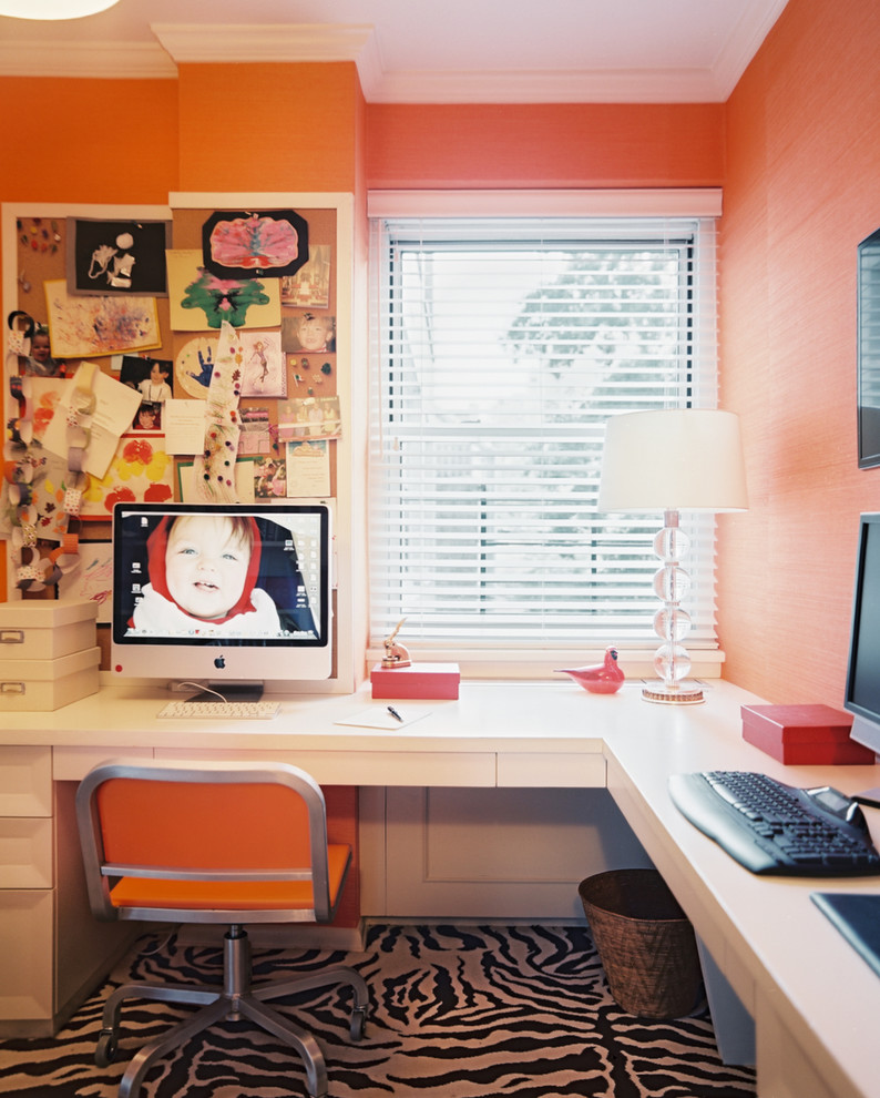 Example of a mid-sized minimalist built-in desk carpeted study room design in New York with orange walls and no fireplace