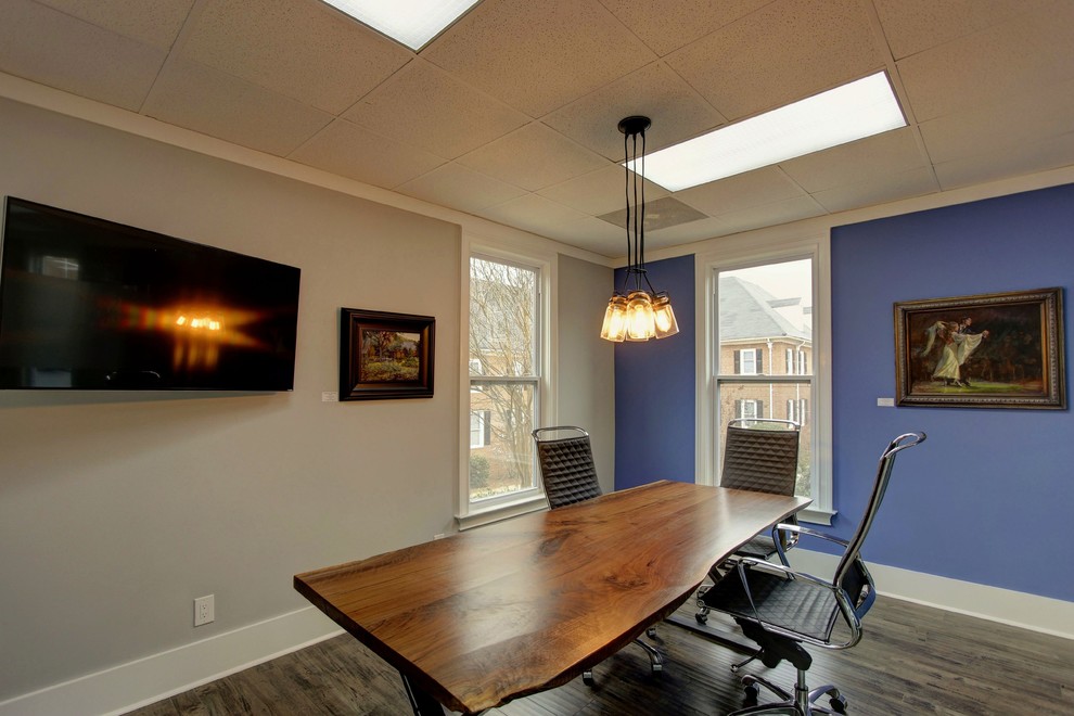 This is an example of a large urban home office in Atlanta with grey walls, medium hardwood flooring and a freestanding desk.
