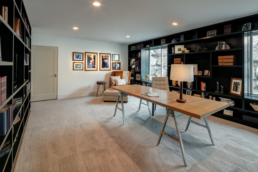 This is an example of a large modern study in Salt Lake City with carpet, no fireplace, a freestanding desk, beige floors and white walls.