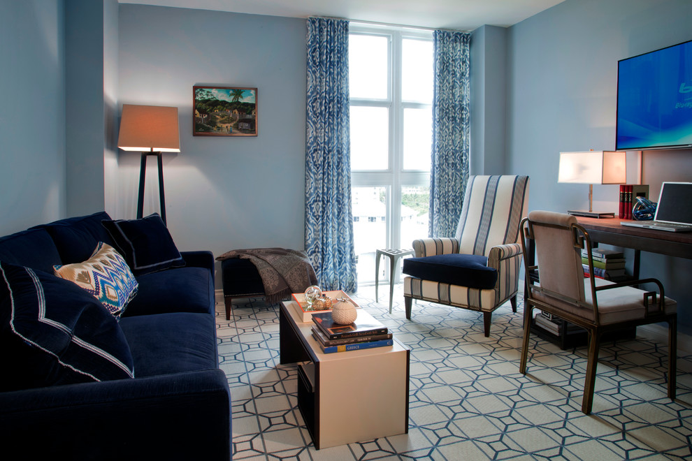 This is an example of a medium sized contemporary study in Miami with blue walls, carpet and a freestanding desk.