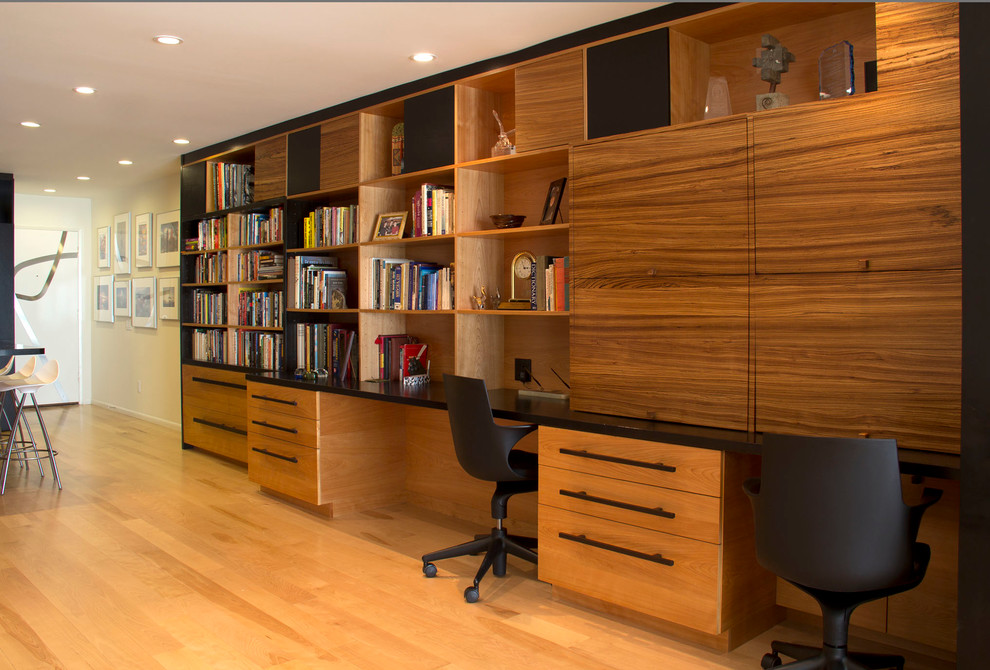 Imagen de despacho minimalista de tamaño medio con paredes blancas, suelo de madera clara y escritorio empotrado