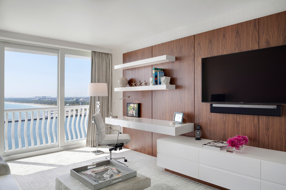 Contemporary study in Miami with white walls, carpet and a built-in desk.