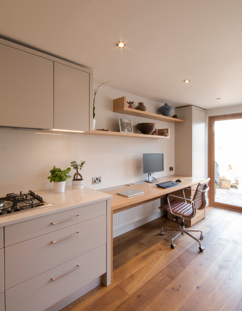 Home office - mid-sized contemporary medium tone wood floor home office idea in Other