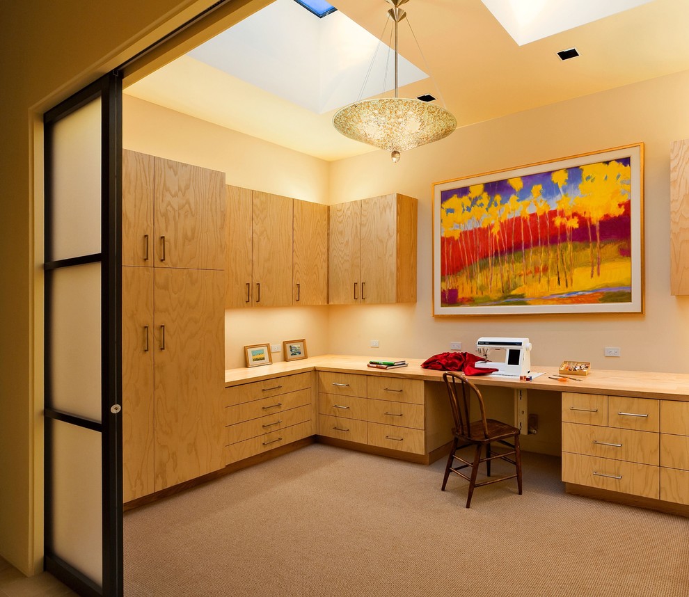 Стильный дизайн: кабинет в современном стиле с местом для рукоделия, бежевыми стенами, ковровым покрытием и встроенным рабочим столом - последний тренд