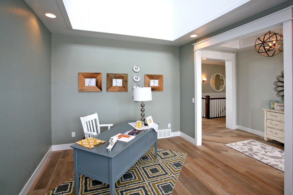 Example of a large trendy freestanding desk medium tone wood floor and brown floor study room design in Salt Lake City with gray walls and no fireplace