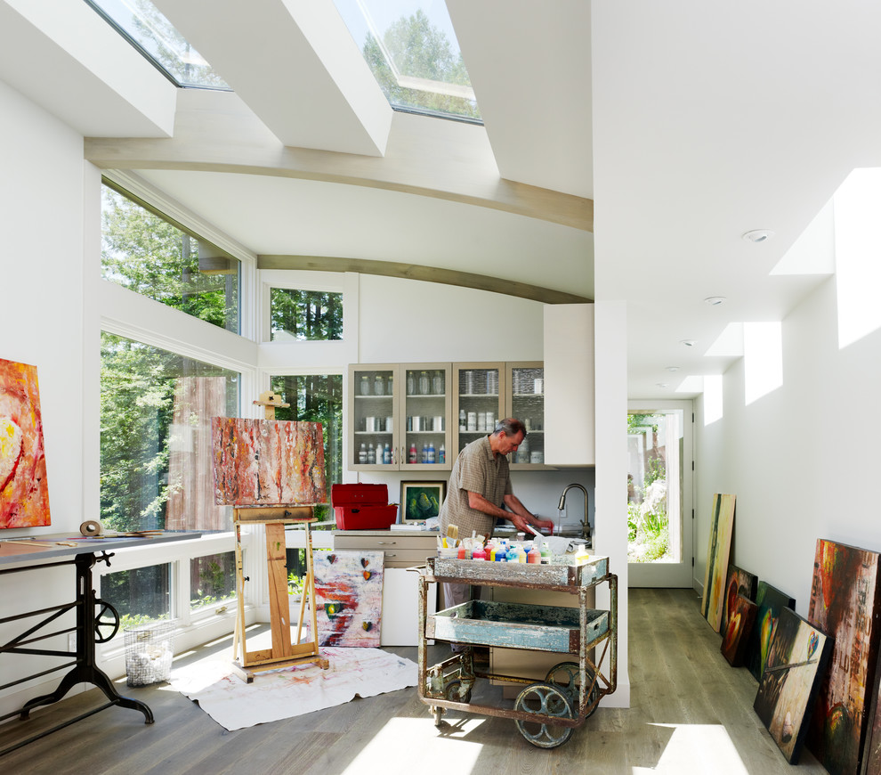 Inspiration for a contemporary medium tone wood floor home studio remodel in San Francisco with white walls