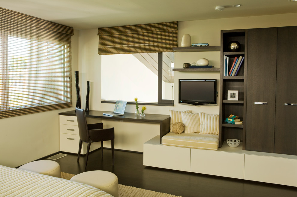 Inspiration for a contemporary built-in desk home office remodel in Orange County with beige walls