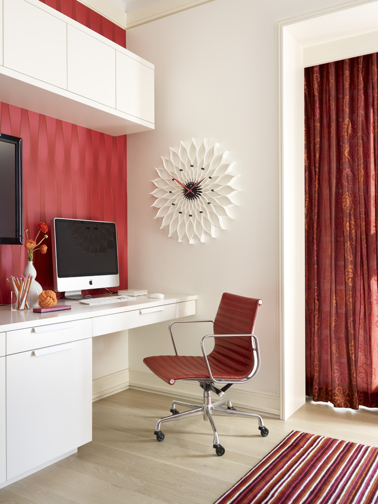 Inspiration for a contemporary home office in Other with light hardwood flooring, a built-in desk and red walls.