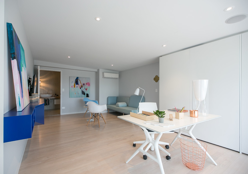 Example of a trendy freestanding desk light wood floor study room design in Hamilton with gray walls