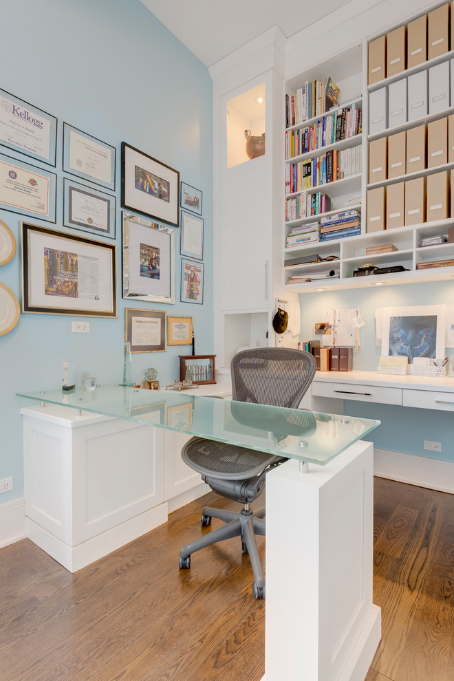 Inspiration for a medium sized contemporary study in Chicago with blue walls, medium hardwood flooring, a built-in desk and brown floors.