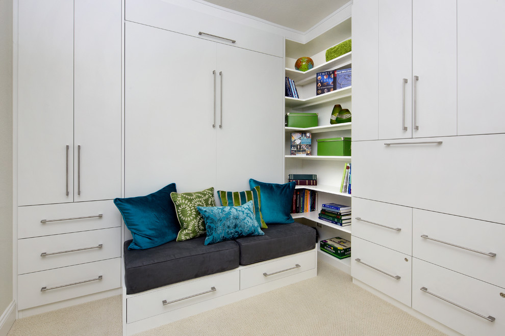 Example of a small trendy built-in desk carpeted study room design in San Francisco with no fireplace and gray walls