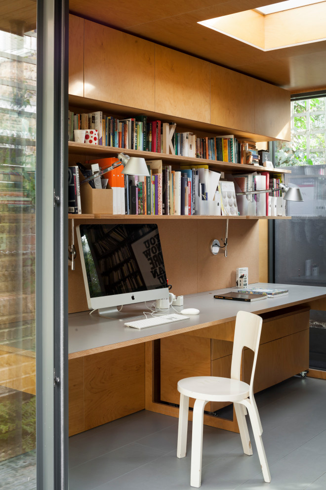 Small contemporary home studio in London with yellow walls, painted wood flooring, a wood burning stove, a metal fireplace surround, a built-in desk, grey floors, a wood ceiling and panelled walls.