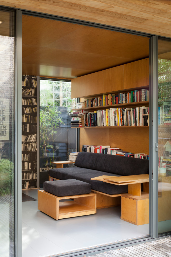 Kleines Modernes Arbeitszimmer mit Studio, gelber Wandfarbe, gebeiztem Holzboden, Kaminofen, Kaminumrandung aus Metall, Einbau-Schreibtisch, grauem Boden, Holzdecke und Wandpaneelen in London