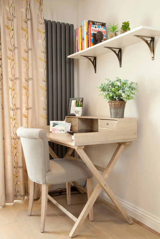 Diseño de despacho contemporáneo pequeño sin chimenea con paredes beige, suelo de madera clara y escritorio independiente