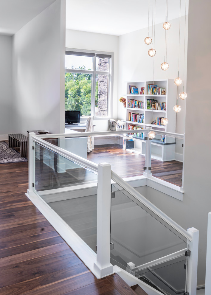 Idee per un piccolo studio design con libreria, pareti bianche, pavimento in legno massello medio, nessun camino, scrivania incassata e pavimento marrone