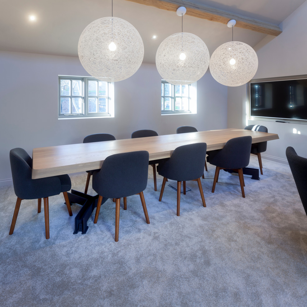 Photo of a large contemporary dining room in Cheshire with white walls and carpet.