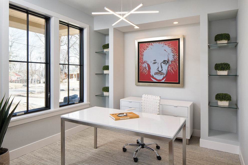 This is an example of a medium sized contemporary study in Minneapolis with grey walls, carpet and a freestanding desk.