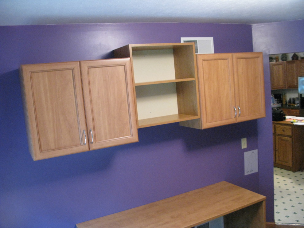 Small classic craft room in Other with purple walls, light hardwood flooring and a built-in desk.