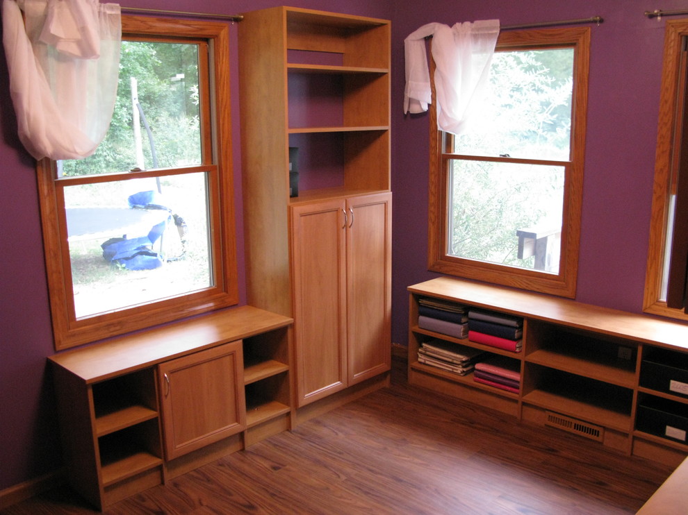 Design ideas for a small traditional craft room in Other with purple walls, light hardwood flooring and a built-in desk.