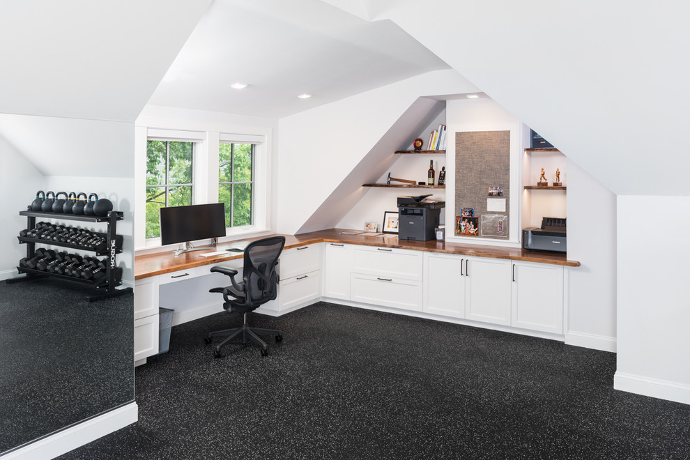Large elegant built-in desk vinyl floor and black floor study room photo in Boston with white walls and no fireplace
