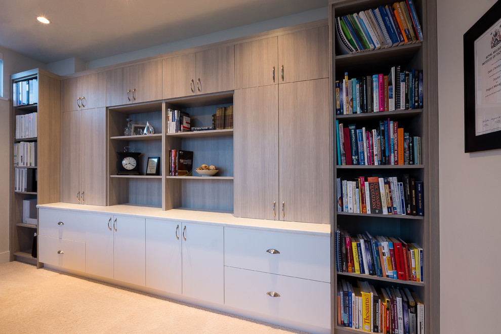 Inspiration för mellanstora klassiska hemmabibliotek, med beige väggar och ett fristående skrivbord
