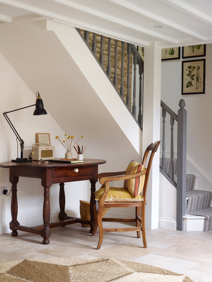 Kleines Landhausstil Arbeitszimmer ohne Kamin mit Arbeitsplatz, weißer Wandfarbe, Kalkstein, freistehendem Schreibtisch und beigem Boden in Oxfordshire