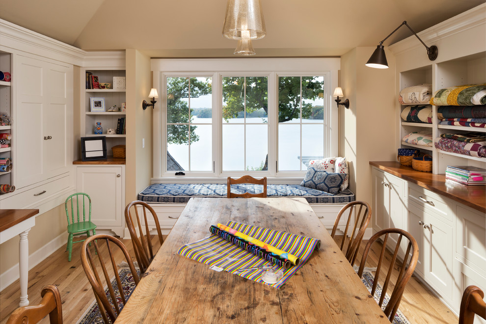 Example of a large classic freestanding desk medium tone wood floor and brown floor craft room design in Minneapolis with beige walls and no fireplace